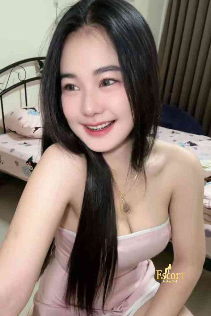 Escort Malay Girl Adeline, a 22yo C Cup Thailand Escort in KL, smiles in a pink dress KL Escort Girl Service