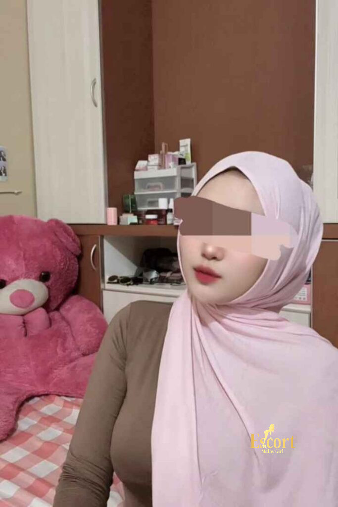 Escort Malay Girl Amina, a 22-year-old petite Malay escort in Kuala Lumpur, wearing a pink hijab. KL Escort Girl Service