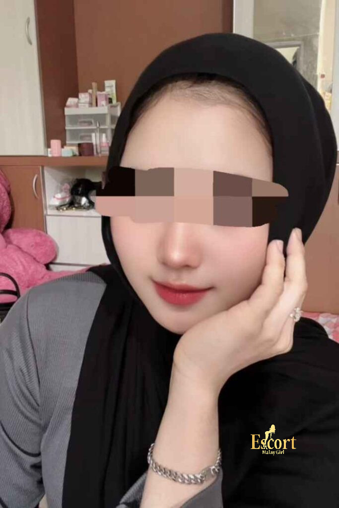 Escort Malay Girl Amina, a petite Malay escort in Kuala Lumpur, smiles while wearing a hijab KL Escort Girl Service