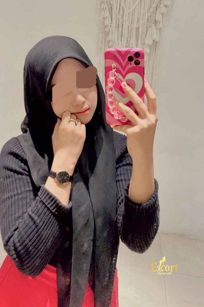 Escort Malay Girl Eika Malay escort in hijab holding phone, Cheras, Klang Valley KL Escort Girl Service