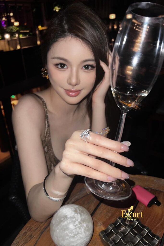Escort Malay Girl Hui Mei Chinese escort enjoying a drink, offering KL services KL Escort Girl Service