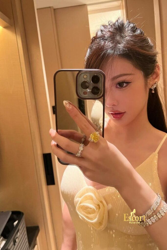 Escort Malay Girl Hui Mei Chinese escort in KL, showing off jewelry and a yellow dress KL Escort Girl Service