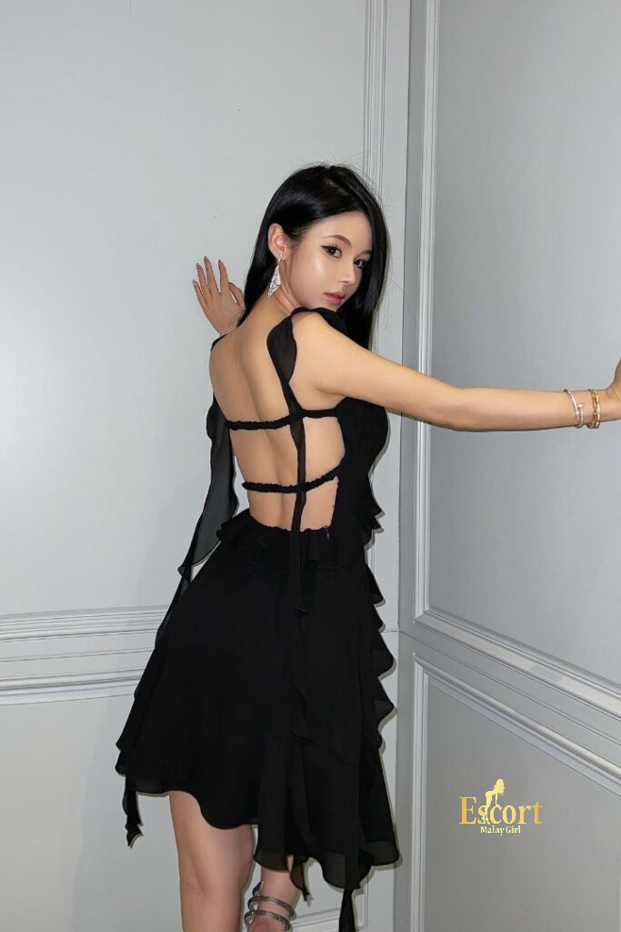 Escort Malay Girl Hui Mei Chinese escort in a black dress, offering KL services. KL Escort Girl Service