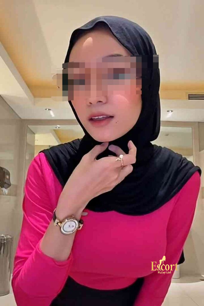 Escort Malay Girl Kirana, a 23-year-old Malay escort with a C cup, wearing a pink shirt and black hijab KL Escort Girl Service