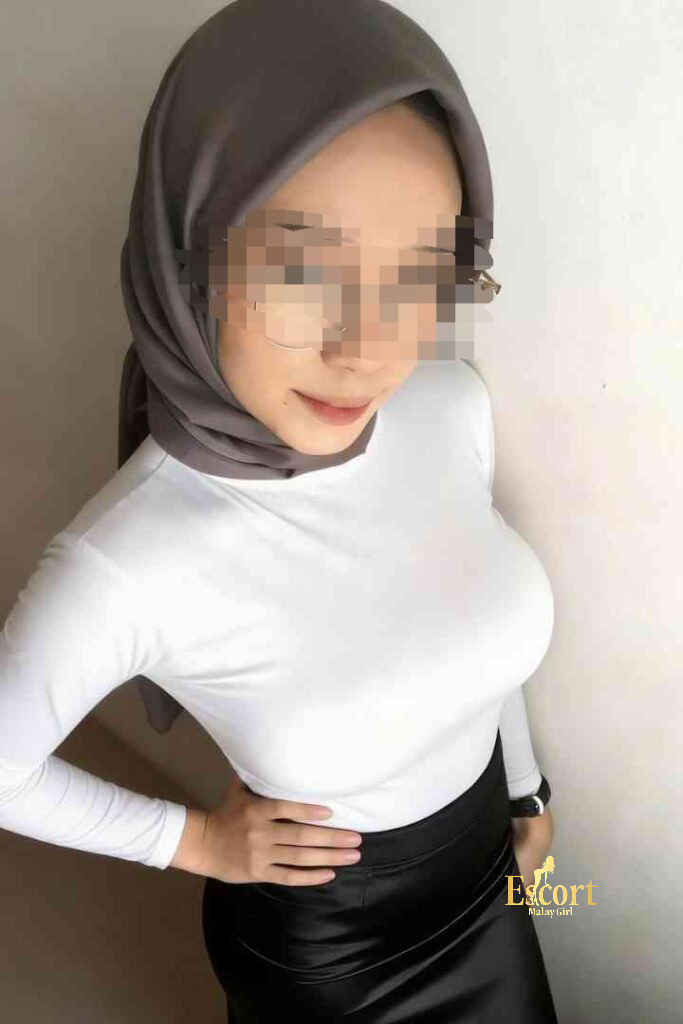 Escort Malay Girl Kirana, 23yo Malay escort with C cup, wearing white top and black skirt, posing for photo KL Escort Girl Service