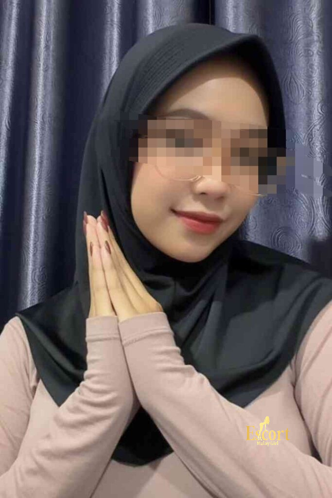 Escort Malay Girl Kirana, a 23yo Malay escort in KL, wears a hijab and glasses, smiling KL Escort Girl Service