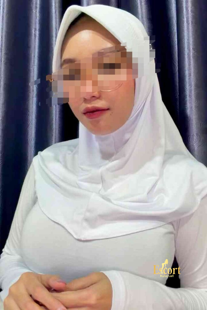 Escort Malay Girl Kirana Malay Escort in white hijab, looking forward with a serious expression KL Escort Girl Service