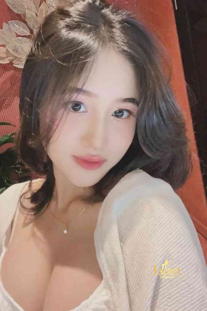 Escort Malay Girl Laila Malay Escort, smiling woman with short hair and necklace in white blouse KL Escort Girl Service