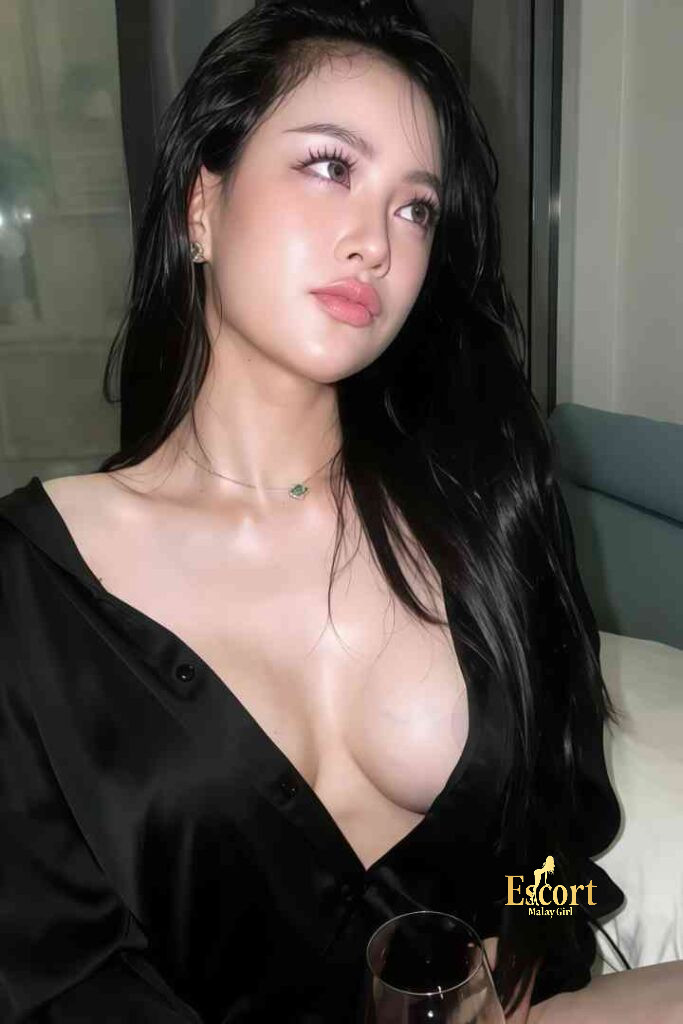 Escort Malay Girl Lainey, a 23-year-old Thai escort in Kuala Lumpur, with long dark hair and a black top. KL Escort Girl Service