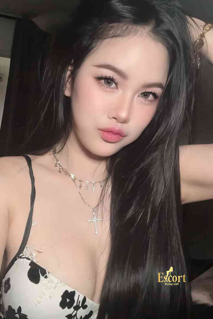 Escort Malay Girl Lainey, a 23-year-old Thai escort and call girl in Kuala Lumpur, with long dark hair and a necklace. KL Escort Girl Service