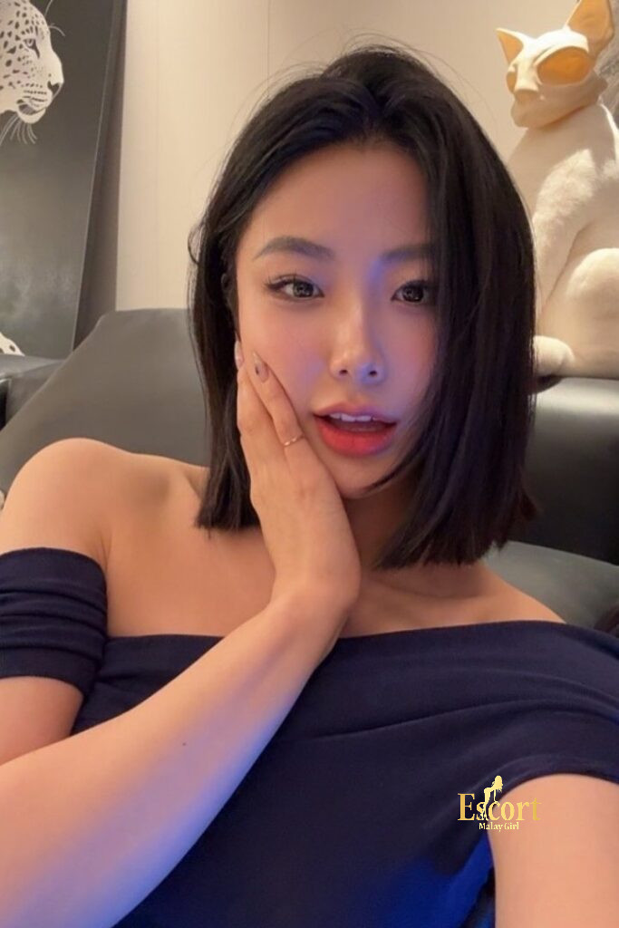 Escort Malay Girl Ling An, 23yo C Cup Chinese Escort KL, posing in a blue off-shoulder dress KL Escort Girl Service