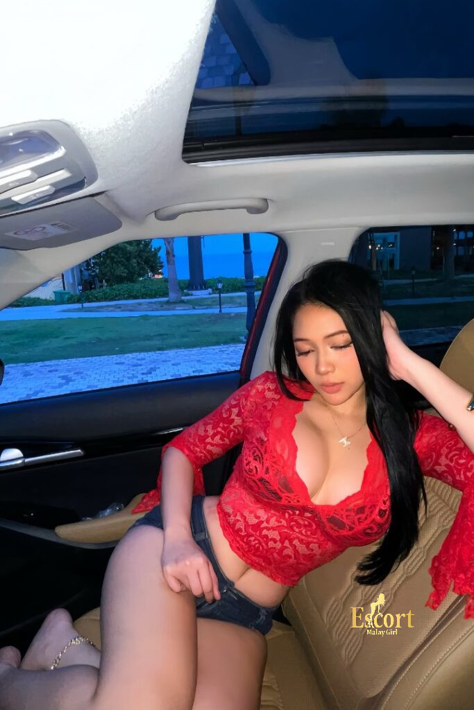 Escort Malay Girl Shawira, a 166cm Malay escort, in a red top inside a car. KL Escort Girl Service