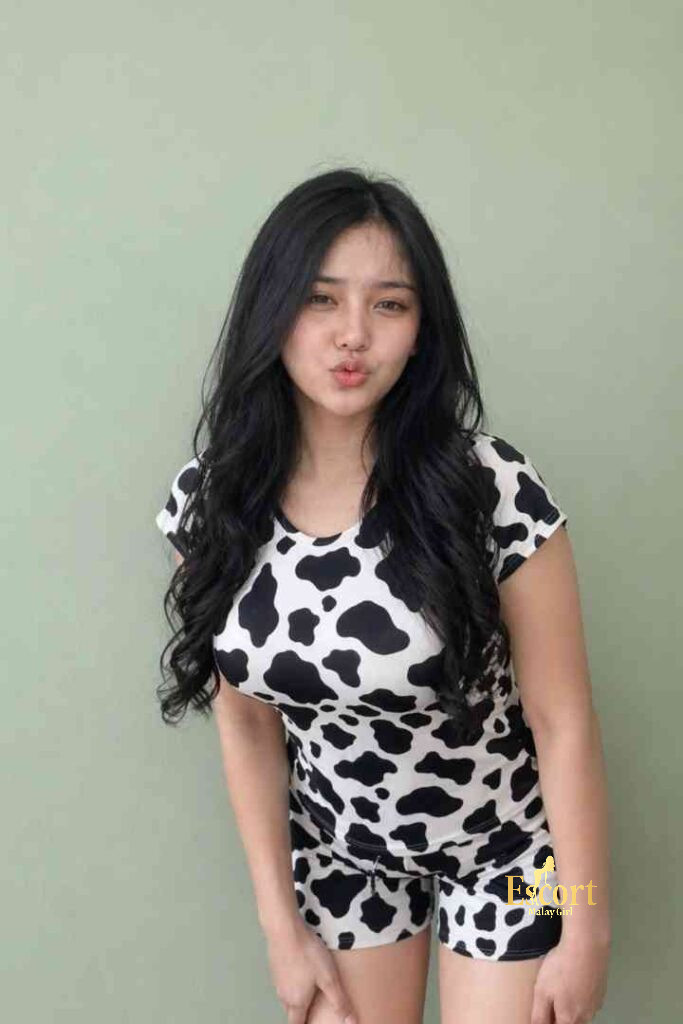 Escort Malay Girl Malay escort Vira, 24, in cow print outfit with Escort Malaysia text KL Escort Girl Service