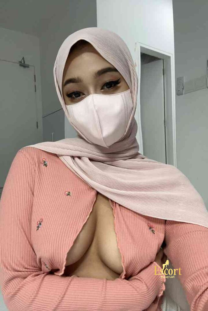 Escort Malay Girl Young Zati, a Malay escort, wearing a hijab and pink top KL Escort Girl Service