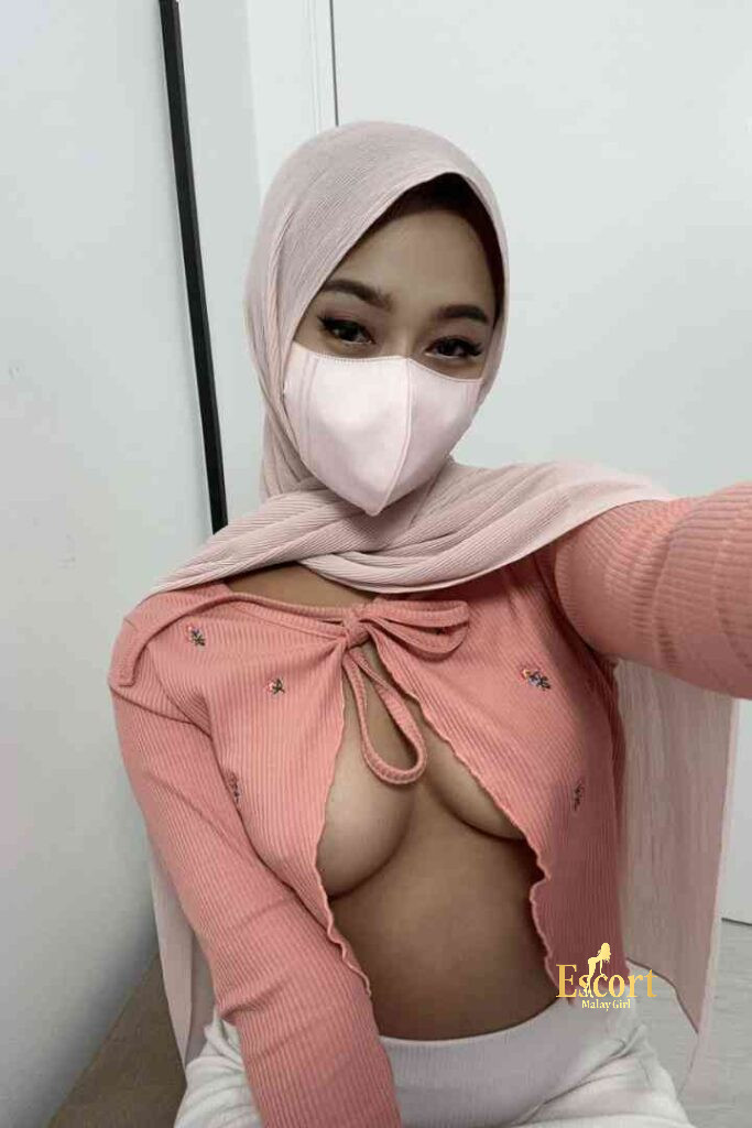 Escort Malay Girl Zati, a young Malay escort, wearing a hijab and pink top KL Escort Girl Service