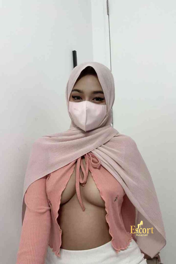 Escort Malay Girl Zati, a young Malay escort, wearing a pink hijab and top KL Escort Girl Service