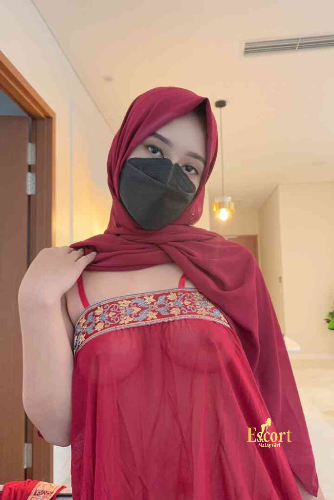 Escort Malay Girl Mira, Malay escort in red, wearing hijab, holding her shawl, Escort Malay Girl KL Escort Girl Service